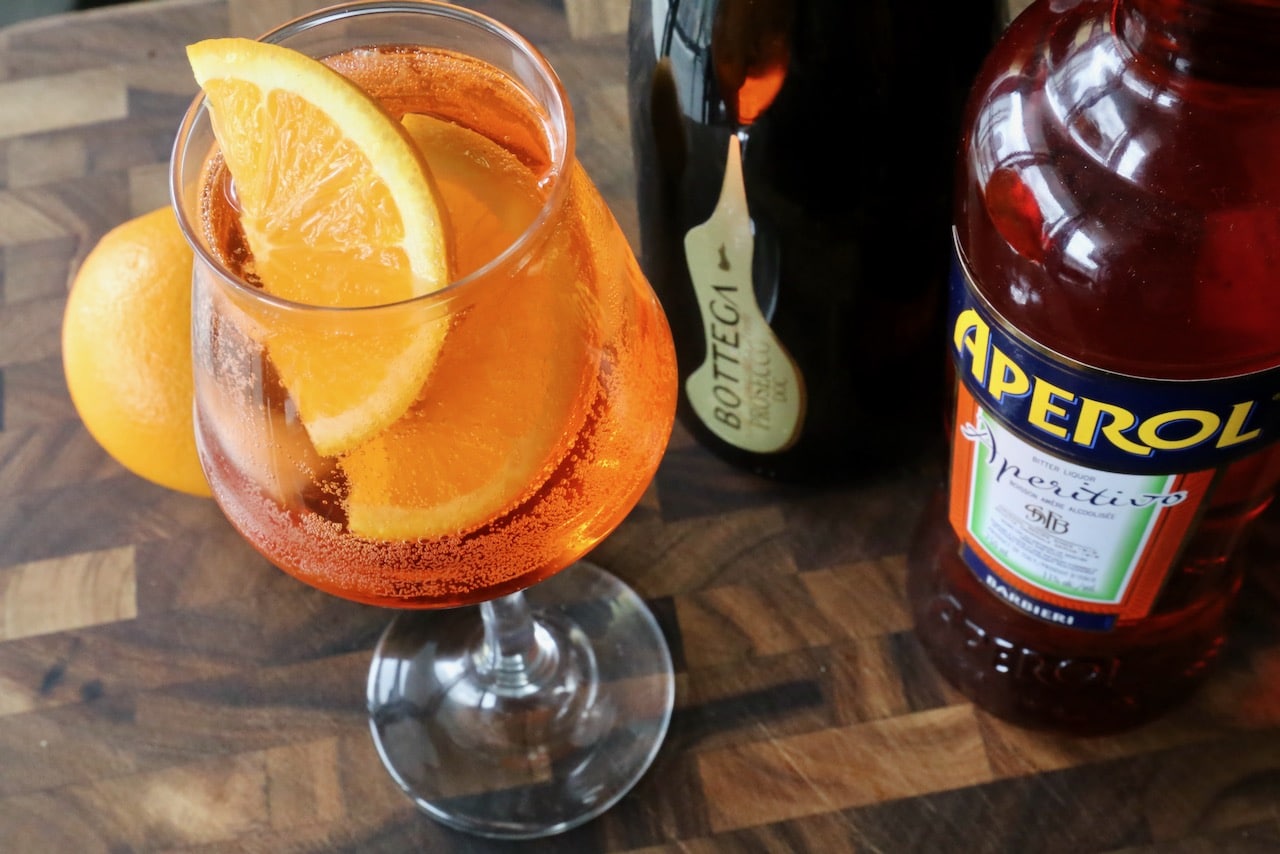 Garnish an Aperol Spritz Veneziano with freshly sliced orange.