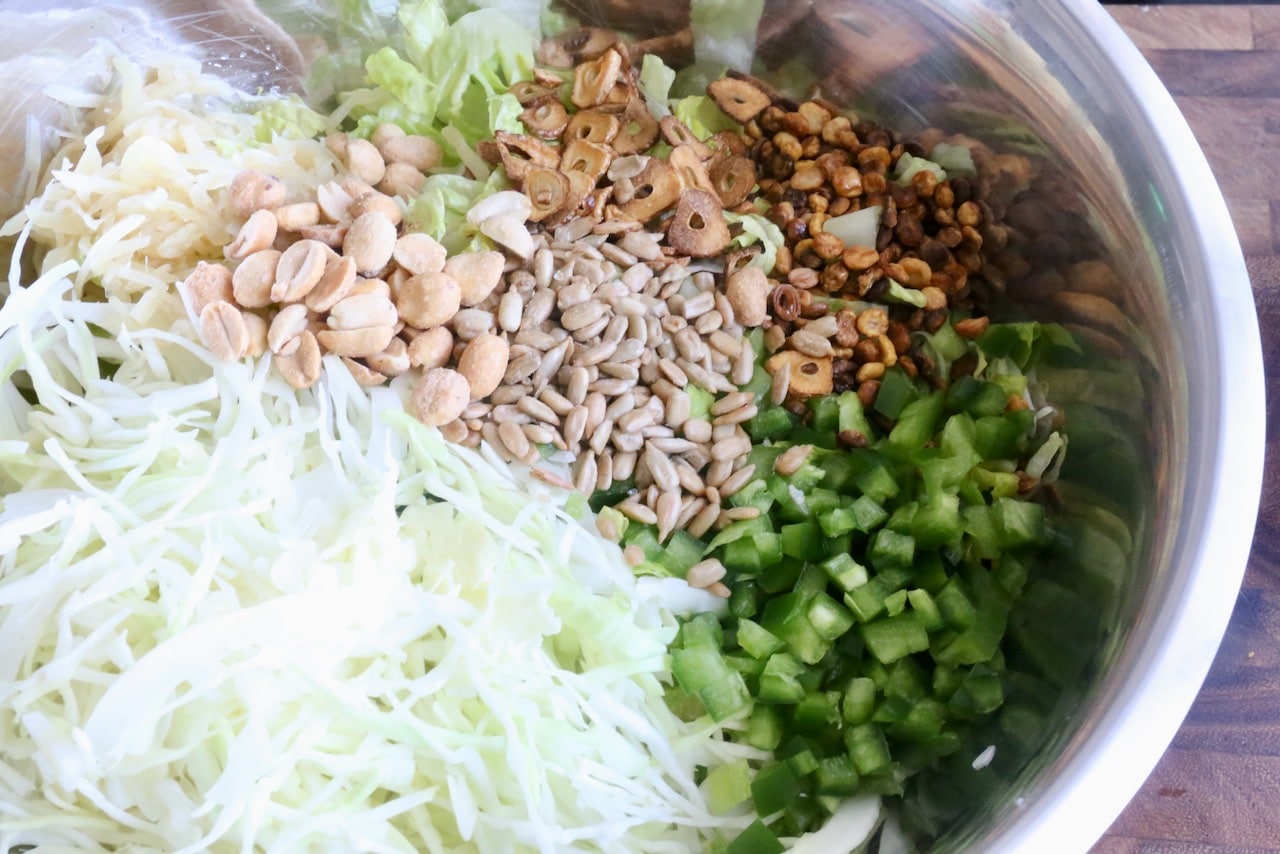 Pickled Ginger Salad is an authentic Burmese recipe featuring shredded cabbage, peanuts and fried garlic.