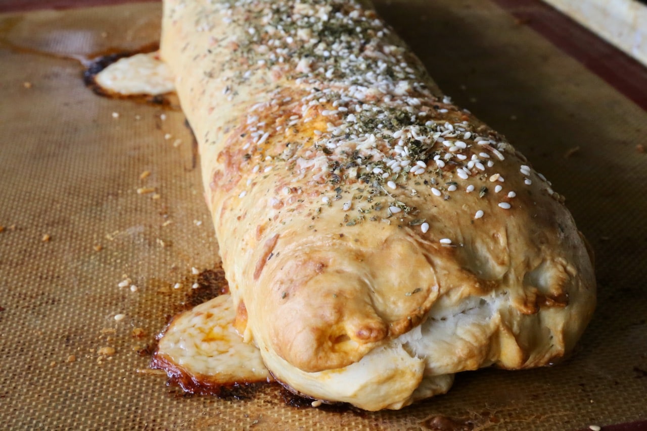 Garnish this authentic Italian Stromboli recipe with herbs and sesame seeds.