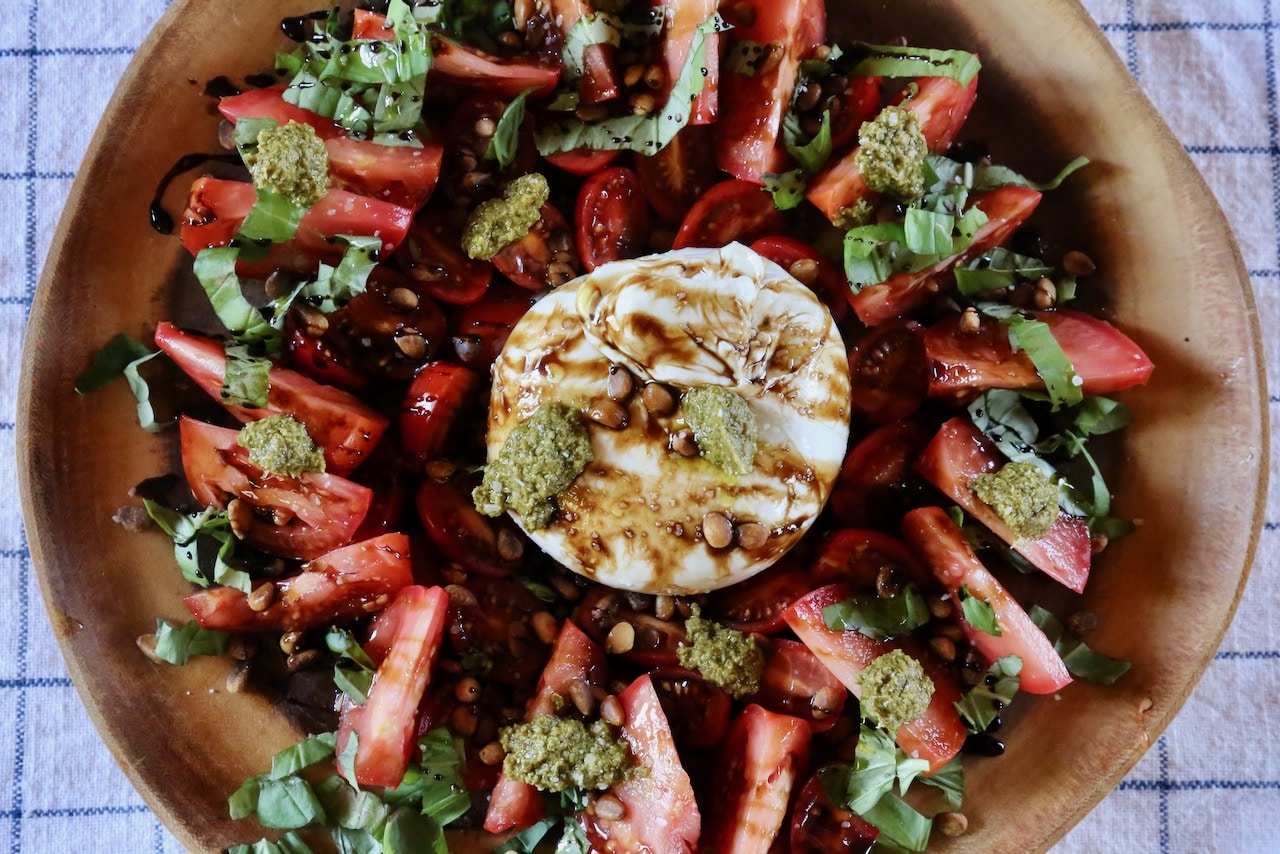 We love serving Burrata Caprese with dollops of pesto and roasted pine nuts.