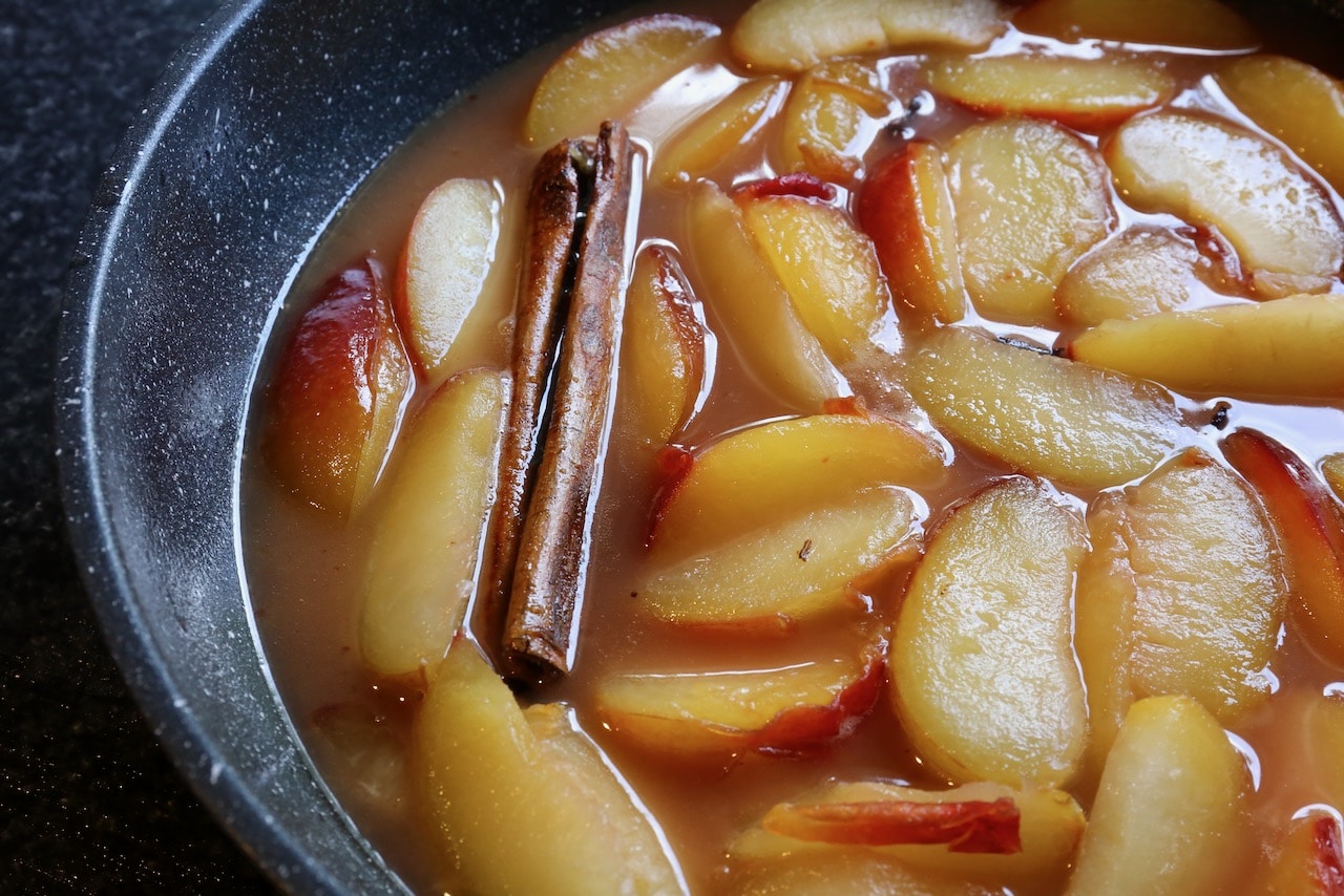 Stew plums until the fruit is fork tender and the syrup has thickened.
