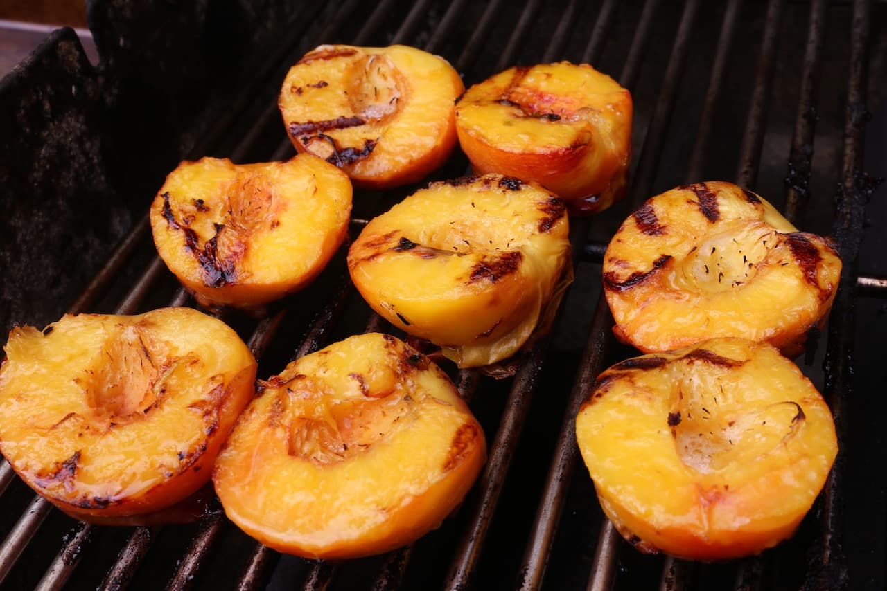 Grill peaches in a hot barbecue. 