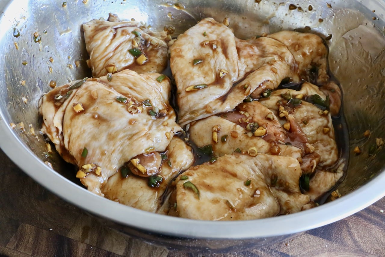 Coat chicken thighs in the marinade for 30 minutes or overnight. 