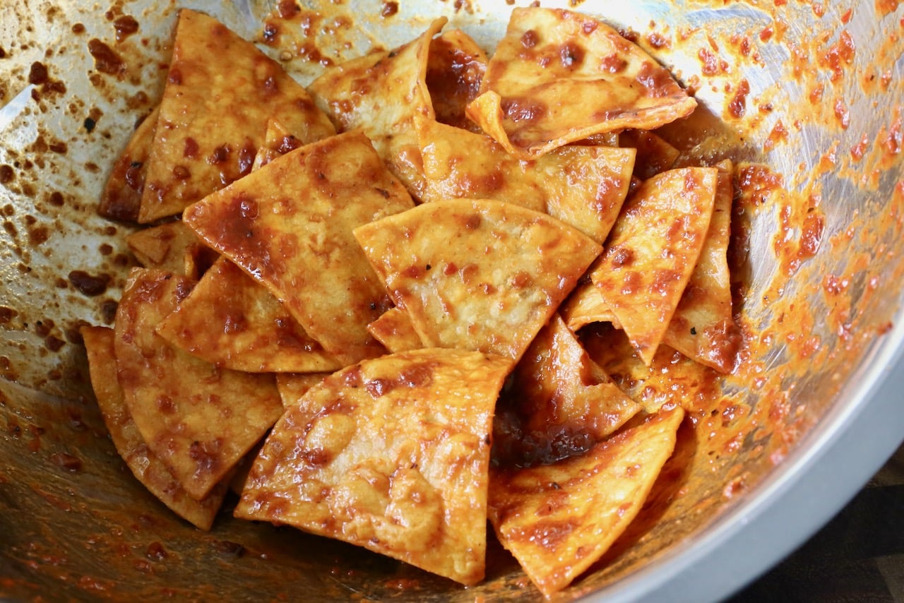 Toss tortilla chips in red chile sauce.