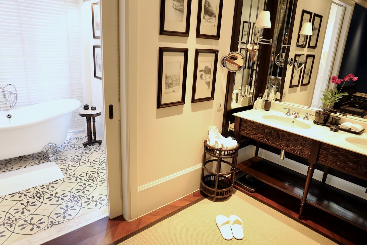 Suite bathrooms features romantic bathtubs and white marble his and her sinks.