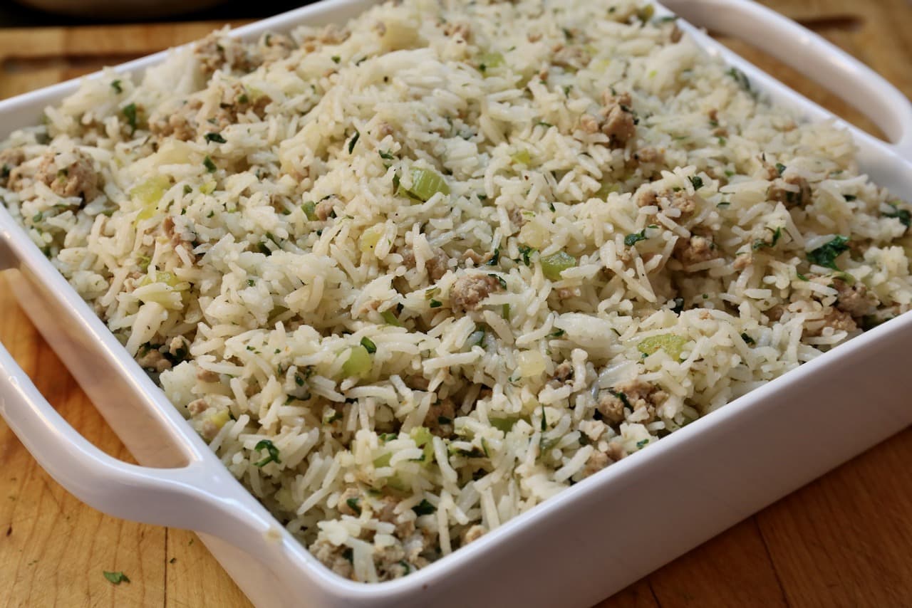 Serve Cajun Rice Dressing at the dinner table in a large casserole dish.
