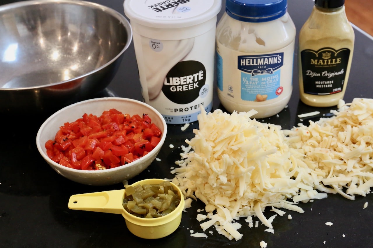 This spicy dip features shredded cheese, Greek yogurt, mayo, mustard, chopped pimentos and pickled jalapeno.