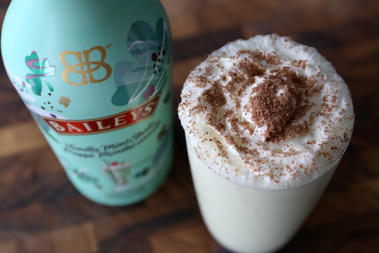 Garnish a Baileys Mint Milkshake with whipped cream and chocolate shavings.