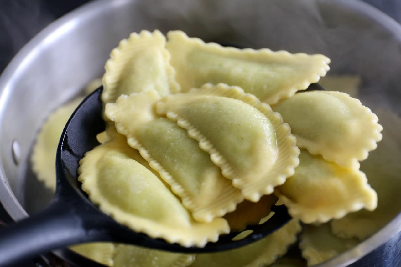 Cook Pansoti stuffed pasta in a large pot of salted water until they float to the top.