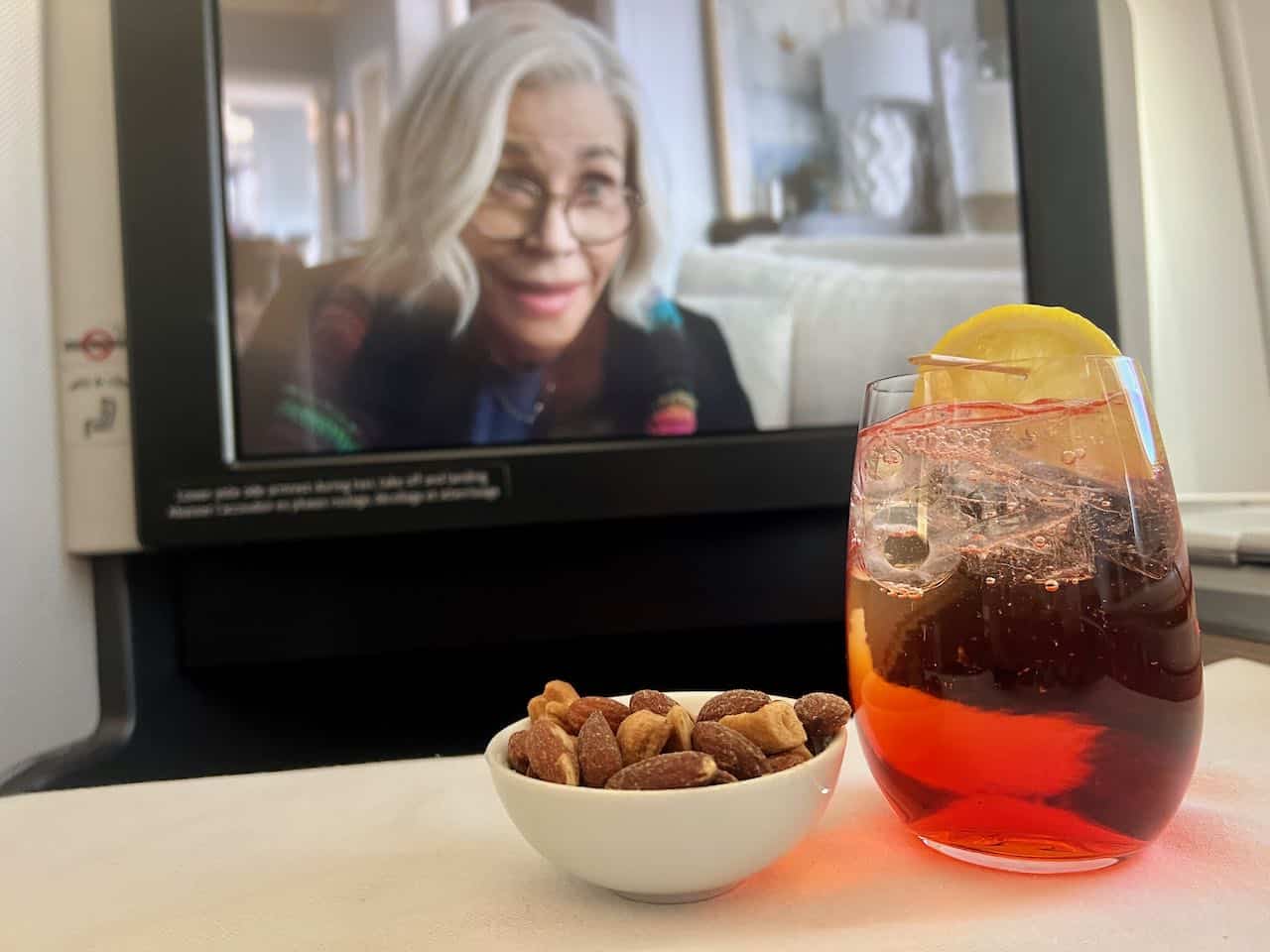Begin your flight from Canada to Thailand with roasted nuts and Aperol Spritz.