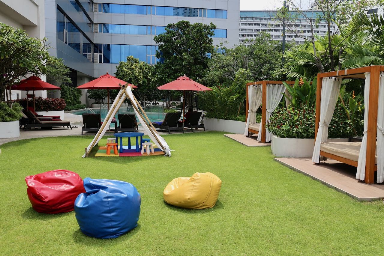 The Amari Bangkok rooftop pool offers lounge chair and cabana seating as well as a tipi for kids! 