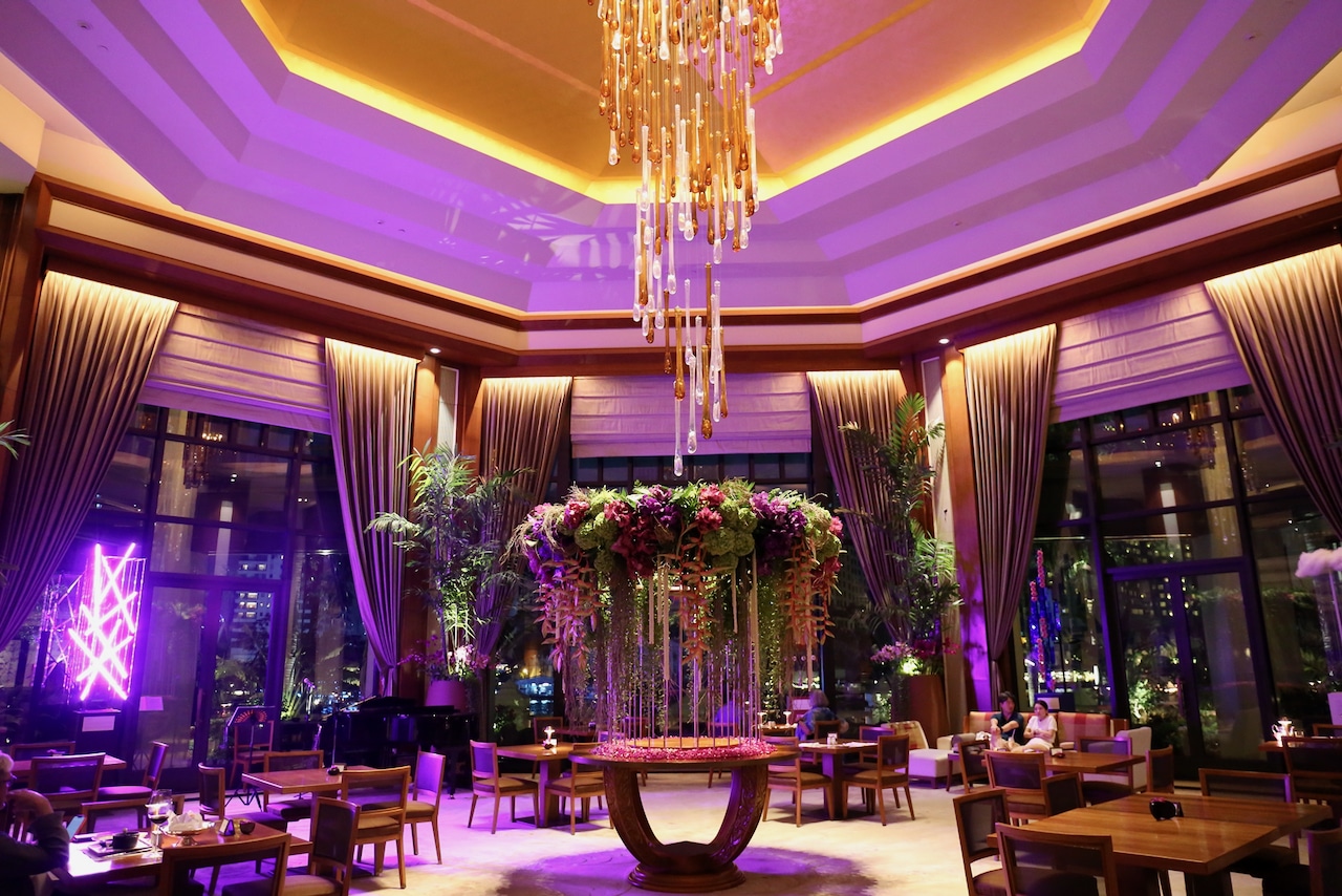 Fresh flowers overflow in the eye-popping Lobby Lounge at Peninsula Bangkok Hotel.