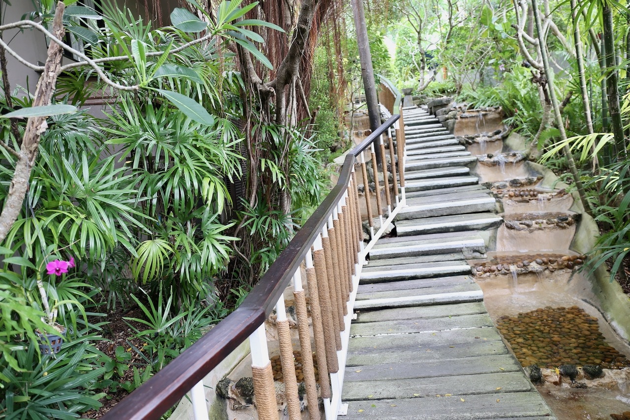 A tranquil garden and waterfall lead the way to Nahm Spa.