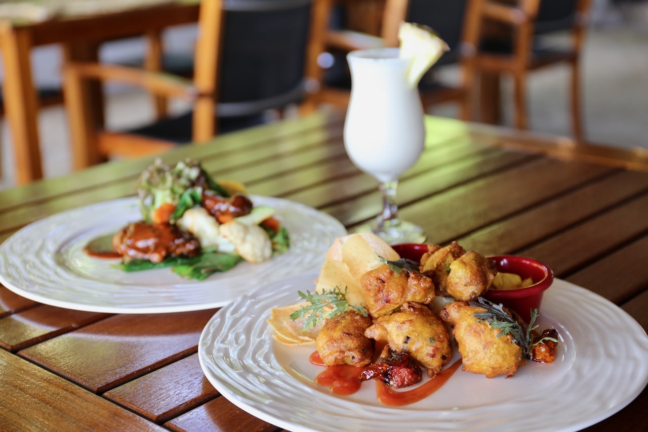 Enjoy a Caribbean lunch paired with a Pina Colada at Trou Au Diable Beach Restaurant.